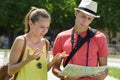 Young lost couple with map outdoors