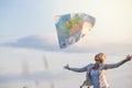 Young Lost Woman Losing a Map Because of the Wind Royalty Free Stock Photo