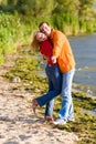 Young love Couple embrace on coast of river Royalty Free Stock Photo