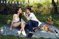 Young love couple have picnic in city park sitting on a blanket Royalty Free Stock Photo