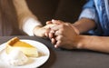 Young lovebirds holding hands while lunch time Royalty Free Stock Photo