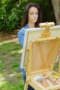 Young lovely caucasian woman painting outdoors Royalty Free Stock Photo