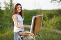 Young lovely caucasian woman painting outdoors Royalty Free Stock Photo