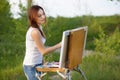 Young lovely caucasian woman painting outdoors Royalty Free Stock Photo