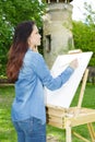 Young lovely caucasian woman painting outdoors Royalty Free Stock Photo