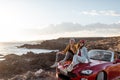 Lovely couple traveling by car near the ocean Royalty Free Stock Photo