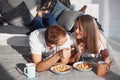 Young lovely couple have a breakfast at home while lying down on bed Royalty Free Stock Photo