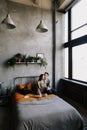 Young lovely couple lying in a bed. Man and woman embracing in bed. Young people deeply in love.  Kissing couple portrait. Royalty Free Stock Photo