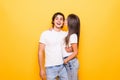 Young lovely couple posing together making selfie and kissing over yellow background Royalty Free Stock Photo