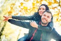 Young lovely happy couple - lovers flying in autumn park