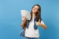 Young lovely happy woman student in glasses with backpack showing thumb up holding bundle lots of dollars, cash money Royalty Free Stock Photo