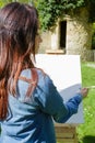 Young lovely woman painting outdoors Royalty Free Stock Photo