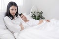 Young lovers in the bedroom . Women are angry. A man sleeping