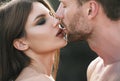 Young lovers hugging and embracing. Sensual kiss closeup. Man kissed tender woman. Couple in love tenderness and