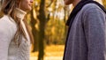 Young lovers looking at each other tenderly, romantic date in autumn forest Royalty Free Stock Photo