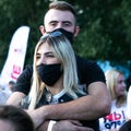 young lovers in protective masks in the park Royalty Free Stock Photo