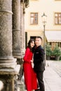 Young loving Asian couple dressed in luxury wear posing near old columns at the old city in summer Royalty Free Stock Photo