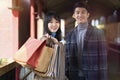 Young loving asian couple with shopping bags Royalty Free Stock Photo
