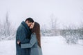 Young loving caucasian couple hugging on natural winter cold background. Human relationship on white empty side space Royalty Free Stock Photo