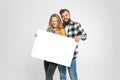 Two happy loving people with mockup poster