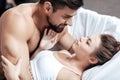 Young loving couple embrace in bed Royalty Free Stock Photo