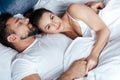 Young loving couple embrace in bed Royalty Free Stock Photo