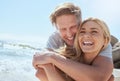 A young loving couple enjoying a day at the beach while smiling hugging and having fun, showing affection at the ocean Royalty Free Stock Photo