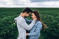 Young loving couple gently hugging on the background of green currant plantations. Love Story Royalty Free Stock Photo