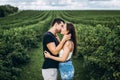 Young loving couple gently hugging on the background of green currant plantations. Love Story Royalty Free Stock Photo