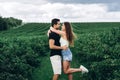 Young loving couple gently hugging on the background of green currant plantations. Love Story Royalty Free Stock Photo