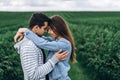 Young loving couple gently hugging on the background of green currant plantations. Love Story Royalty Free Stock Photo