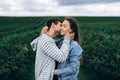 Young loving couple gently hugging on the background of green currant plantations. Love Story Royalty Free Stock Photo