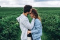 Young loving couple gently hugging on the background of green currant plantations. Love Story Royalty Free Stock Photo