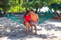 Young loving couple in a hammock at exotic resort Royalty Free Stock Photo