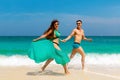 Young loving couple having fun on tropical beach. Summer vacation concept. Royalty Free Stock Photo