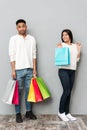 Young loving couple holding shopping bags. Royalty Free Stock Photo