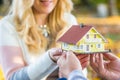 Young loving couple holding small model house Royalty Free Stock Photo