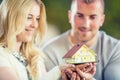 Young loving couple holding small model house Royalty Free Stock Photo