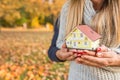 Young loving couple holding small model house. Royalty Free Stock Photo