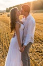 Young loving couple kissing in a field Royalty Free Stock Photo