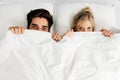 Young loving couple lying on the bed, enjoying Royalty Free Stock Photo