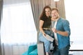 Young loving couple man and woman looking excited, husband gives keys from their new apartment to happy wife