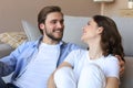 Young loving couple relaxing on floor near sofa together. Woman man embrace enjoy company of each other sitting on couch Royalty Free Stock Photo