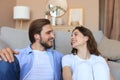 Young loving couple relaxing on floor near sofa together Royalty Free Stock Photo