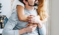 Young loving couple sitting on the pier near a frozen lake. Like children.Close up portrait of happy couple hugging on the Royalty Free Stock Photo