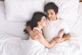 Young loving couple sleeping in bed and hugging Royalty Free Stock Photo