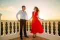 Young loving couple standing next to the stone gazebo with the s Royalty Free Stock Photo