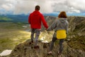 Young loving couple of tourists holding hands standing on top of Royalty Free Stock Photo