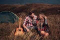 Young loving couple of tourists in the nature. Handsome man and beautiful woman hugging near tent in camping. Happy Royalty Free Stock Photo