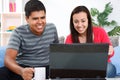 Young loving couple using laptop at home Royalty Free Stock Photo